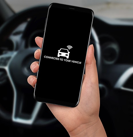 Hand holding phone connected to car multimedia